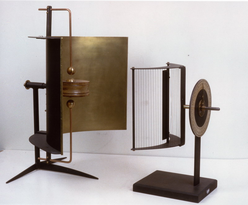 Replica of experimental microwave spark oscillator invented by Augusto Righi around 1894. These oscillators, connected to an induction coil, radiated radio waves with wavelengths less than 10 centimeters in the microwave band. The parabolic reflector focused the radiation into a beam. This type of spark oscillator, invented by Righi (which was based on previous studies by the scientists of Ginevra De la Rive and Sarazin) consisted of 4 brass spheres.  The outer 2 were connected to the induction coil which applied a high voltage causing sparks between the spheres.  The two inner spheres acted as resonators radiating the microwaves.  The spark gaps were surrounded by a vaseline oil bath which decreased the energy losses.  These oscillators were used with a receiver also equipped with a parabolic reflector (see attached photographic documentation and object number 8758).   Righi used them to duplicate classical optics experiments with radio waves, using quasioptical components such as lenses and prisms of paraffin and sulfur and wire diffraction gratings to refract and diffract radio waves like light waves, to confirm the historic 1887 experiments of Heinrich Hertz, that radio waves and light waves were both forms of electromagnetic waves, differing only in frequency.  Righi's oscillators also had great importance for the development of radio communications; in fact fellow Bolognese Guglielmo Marconi the inventor of practical radio in his first experiments in wireless telegraphy used a Righi type oscillator.