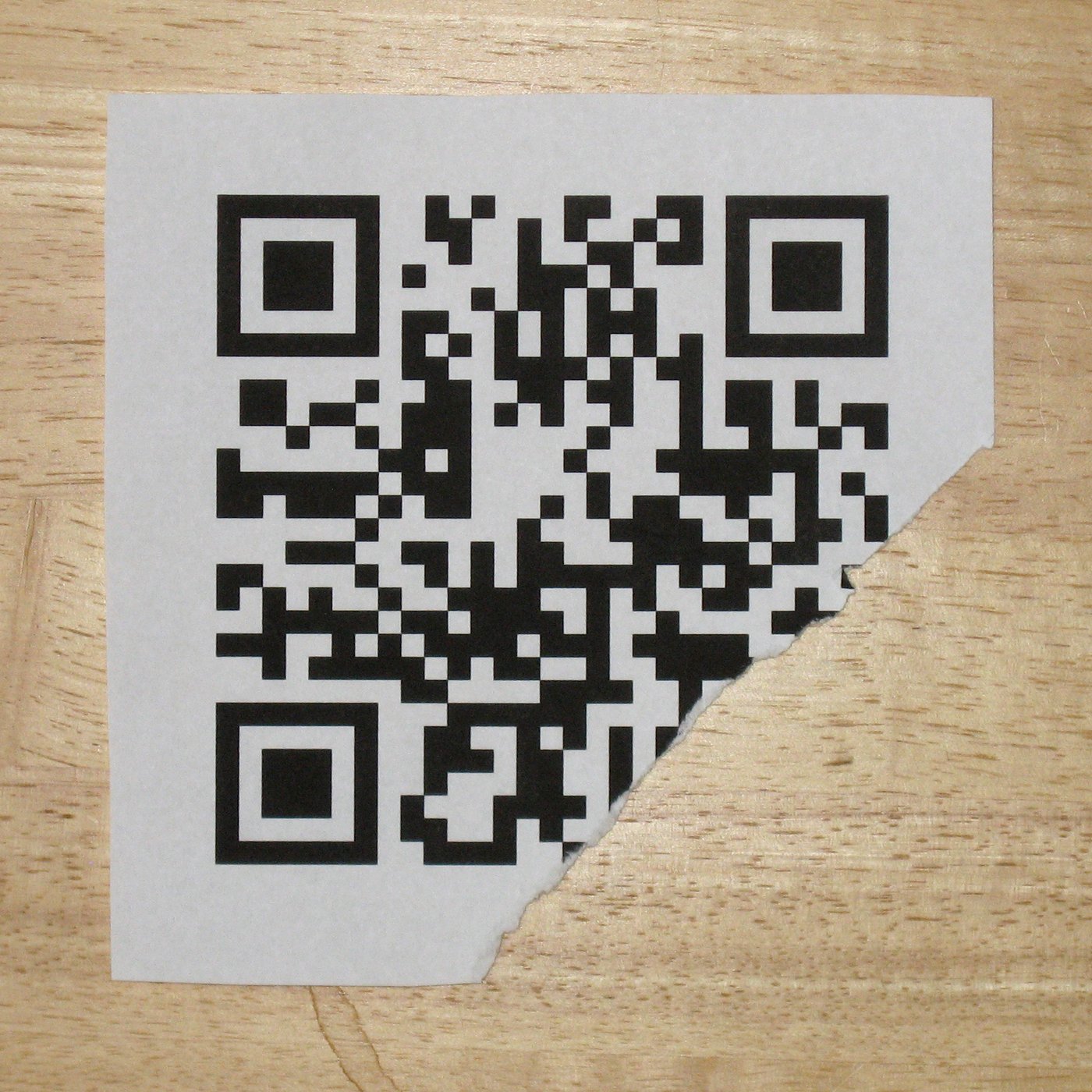 Still readable QR Code, with error correction level "Q" (25%), damaged in 15 bytes of a total 70 split into two blocks. The damage is within the allowed limit of 9 bytes per block of 35. The content is http://en.m.wikipedia.org